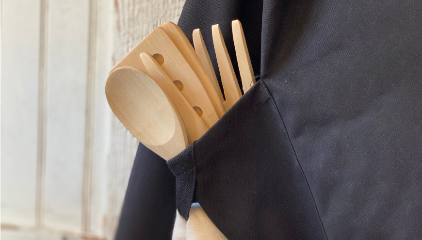  wooden kitchen utensil in an apron