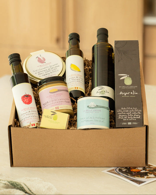 A curated  La Belle Excuse gourmet gift box featuring organic Agorelio olive oil, lemon and raspberry white balsamic vinegars, French shallot confit, roasted garlic mustard, Mediterranean fleur de sel, and rosemary, lemon and coffee kitchen soap.