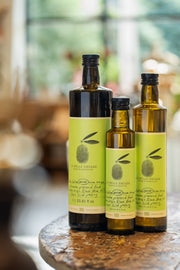 Three formats of La Belle Excuse Extra Virgin Black Olive Oil, made with Greek olives: 250 ml, 500 ml, and 1 L.
